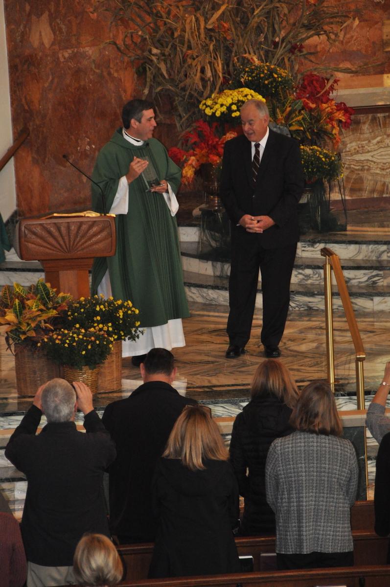 Fr. Larry Sullivan presents inaugural Vivat Christus Rex Award to Mike Heeney at the Christ the King altar on Oct. 27, 2019